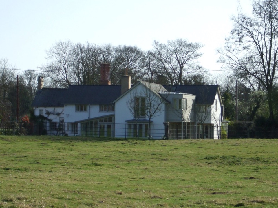 A white house seen across an open green field at Thriplow in Cambridgeshire